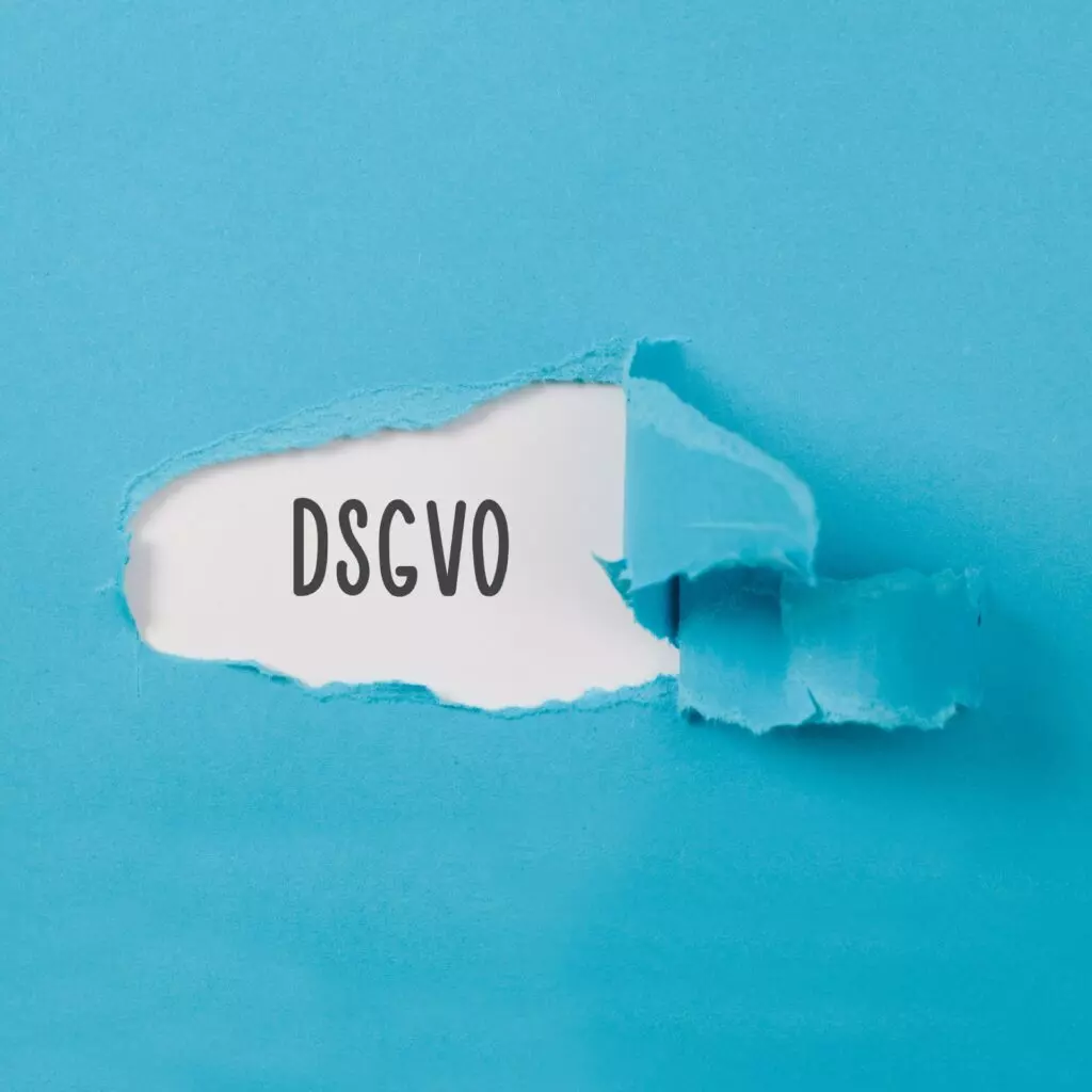 Aufgerissenes Papier enthüllt den Schriftzug ‚DSGVO‘ als Symbol für Datenschutz-Offenlegung.